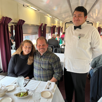 a group of people sitting at a table eating food