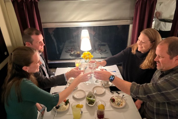a group of people sitting at a table with wine glasses