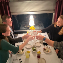 a group of people sitting at a table with wine glasses