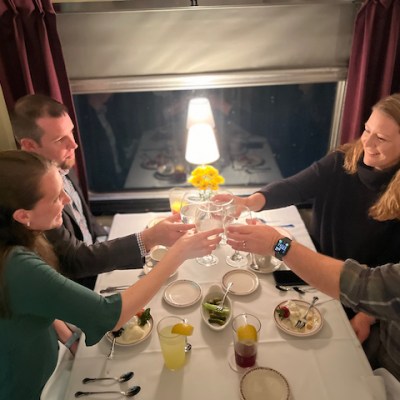 a group of people sitting at a table with wine glasses