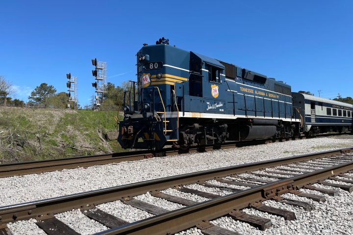 Tag 80 engine is a train traveling down the train tracks in Chattanooga. This image is perfect for those who are interested in the Tennessee Valley Railroad Museum, as it captures the local mission Ridge Train in all of its glory.