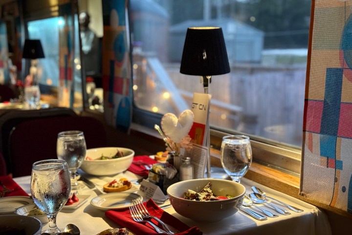 Romantic candlelit dinner setup aboard the Tennessee Valley Railroad Valentine Train Ride with soft lighting and red décor.