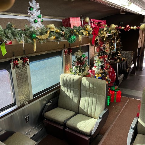 Christmas tree and presents inside the North Pole Limited Santa Car.