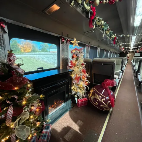 Festive Christmas lights and décor inside the North Pole Limited train car.