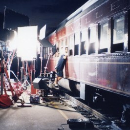 a train is parked on the side of a building