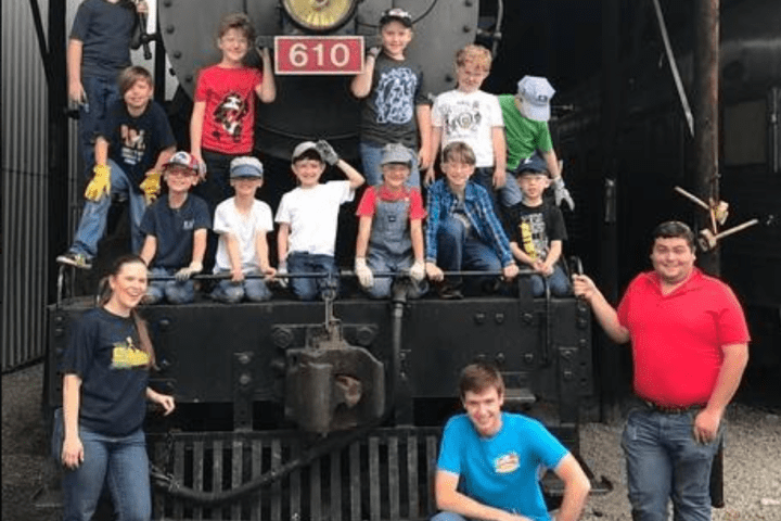 a group of people standing in front of a train