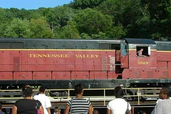 a group of people riding on the back of a train