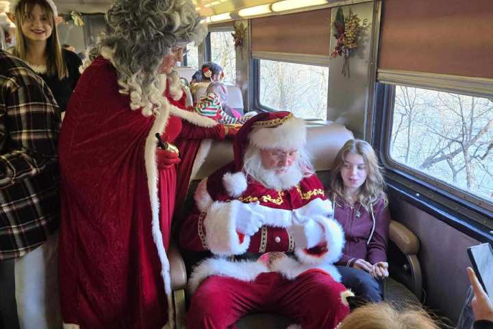 Santa and Mrs. Claus greeting children aboard Santa’s Hiwassee Train Ride