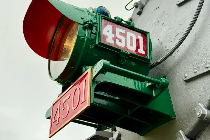 Close-up of green locomotive front with red number 4501 on signs and headlamp.