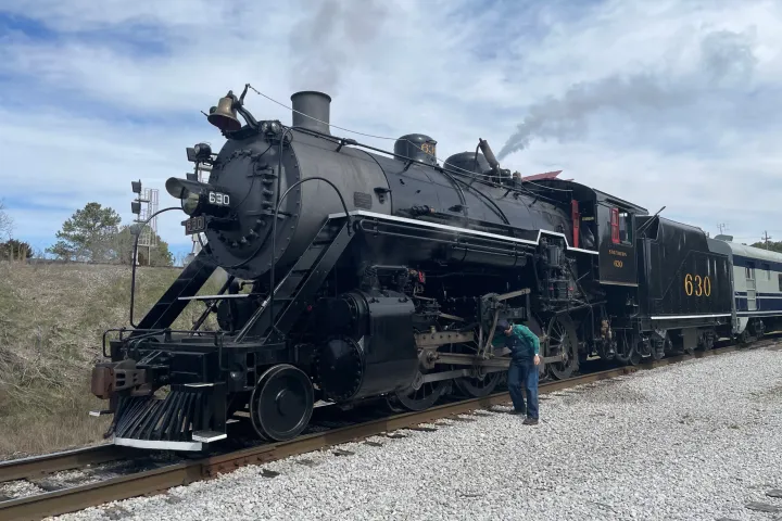 Steam locomotive number 630 with engineer on side