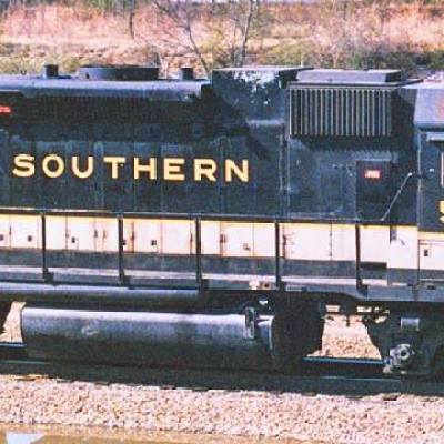 a train is parked on the side of a building