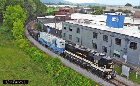 a train is parked on the side of a building