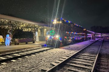 Decorative holiday lights illuminating the Tennessee Valley Railroad Museum in Chattanooga, creating a festive atmosphere for visitors.