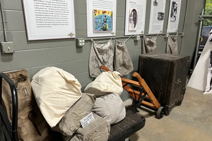 Experience the intrigue of the 1920s railway postal service with our display featuring an antique safe and mail bags at the Tennessee Valley Railroad Museum.