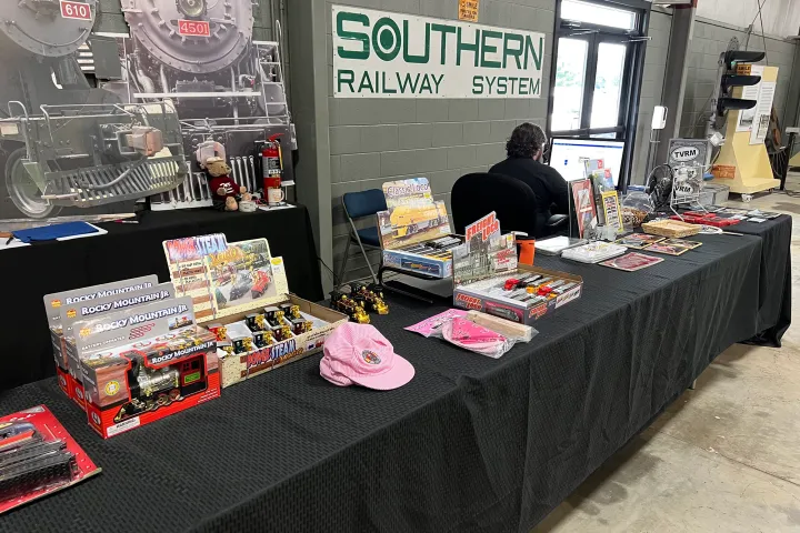 a group of people standing around a table