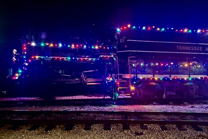 a close up of a train on the tracks at night