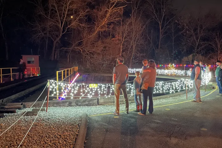 a group of people walking down a dirt road