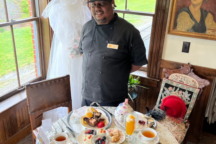 a person standing in front of a cake