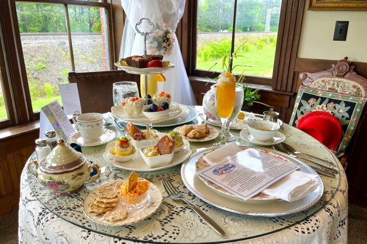 a plate of food on a table next to a window