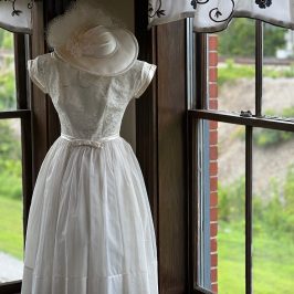 The white dress is adorned with lace and tulle, and makes for a stunning sight.