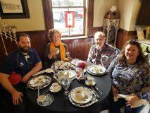 a group of people sitting at a table eating food