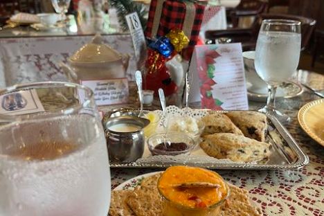 Table set with appetizers, water glasses, and festive decor in a cozy restaurant setting.