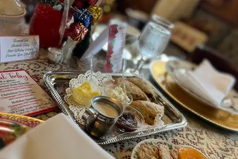 Festive holiday table with snacks, gift decor, and a menu card.