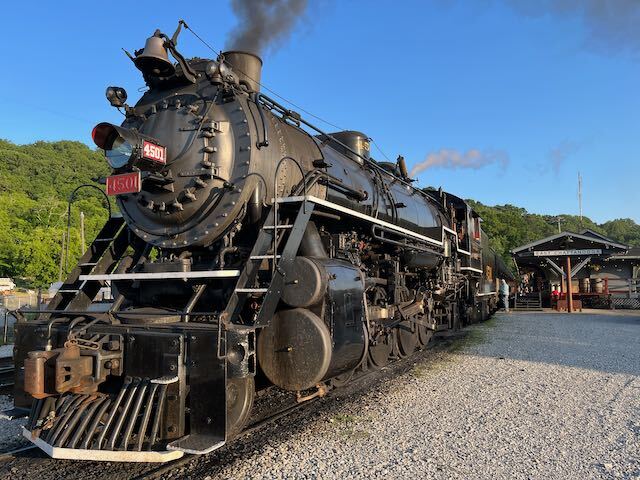 a steam engine is sitting on a train track