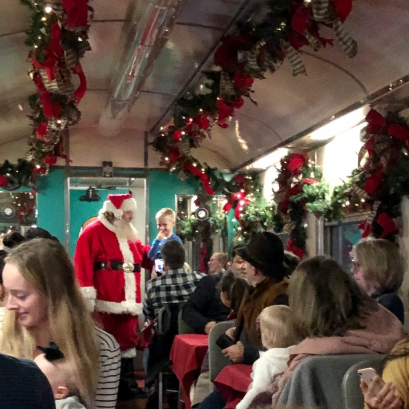 As the North Pole Limited train glides along, I am mesmerized by the beautiful lighted displays that are visible out of the windows. When we finally arrive at the North Pole, Santa himself comes on board to welcome all of the passengers with a festive greeting and warm wishes for the holiday season. It is a magical experience that I will always remember fondly.