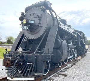 a steam engine is sitting on a train track