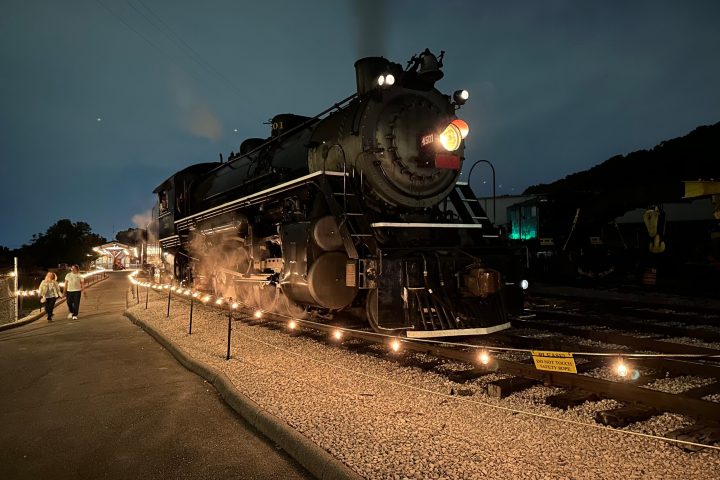 a steam engine is sitting on a train track