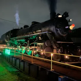 a steam train on the tracks at night