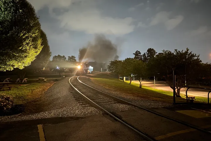a train on a track with smoke coming out of it