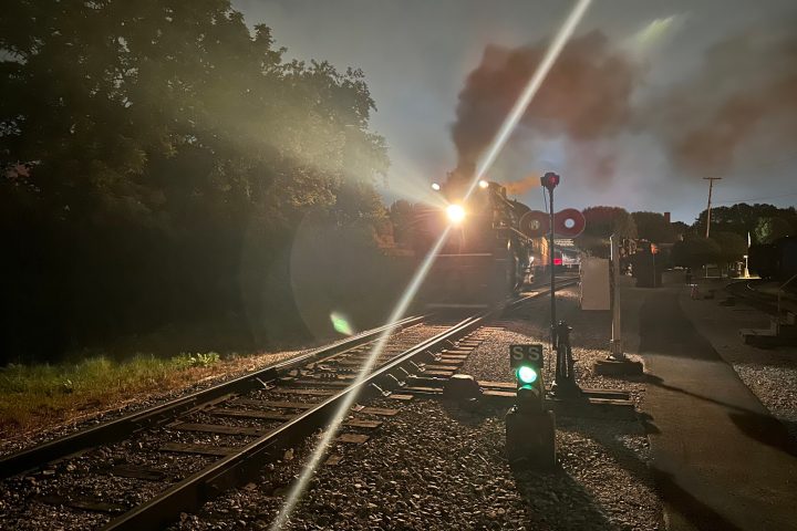 a train on a track with smoke coming out of it