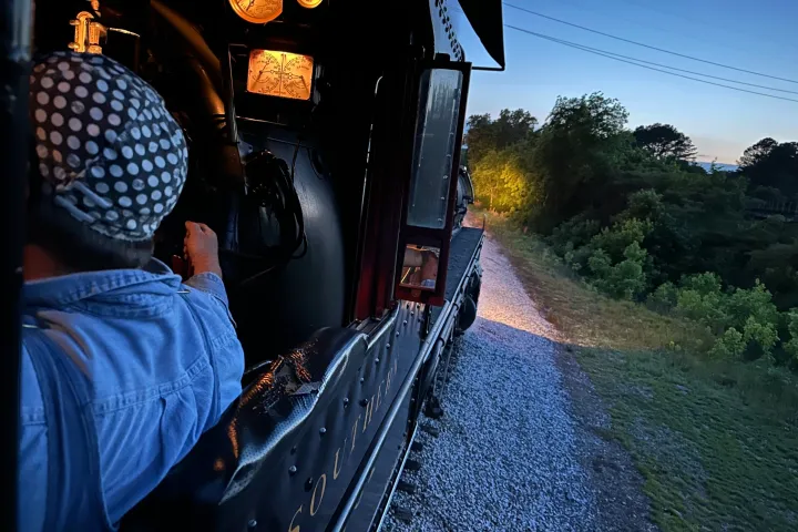 a person standing next to a train
