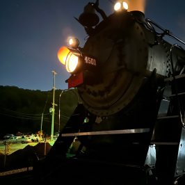 a steam engine sitting in a dark room