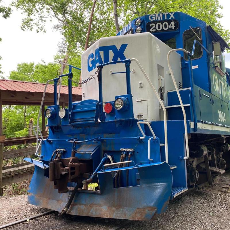 a blue train on a steel track