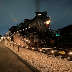 a steam engine is sitting on a train track