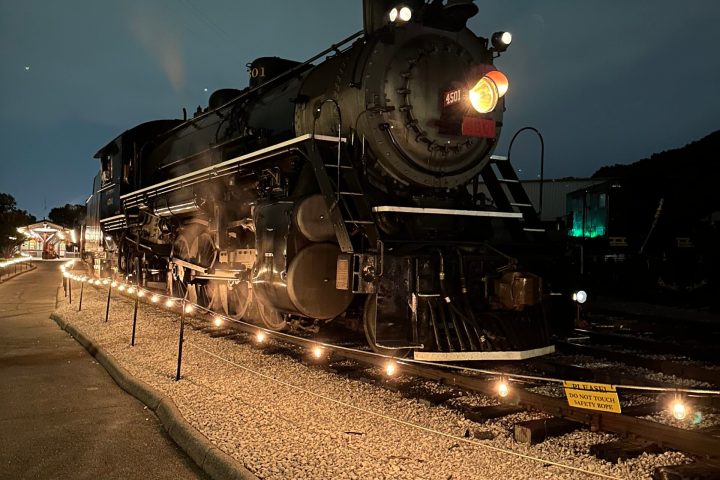 a steam engine is sitting on a train track