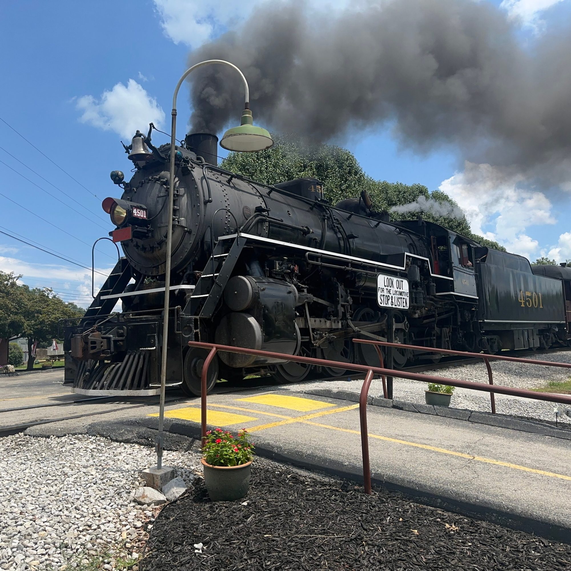 a steam engine is sitting on a train track