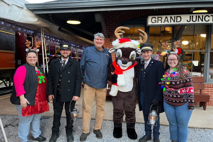 a group of people standing in front of a crowd posing for the camera