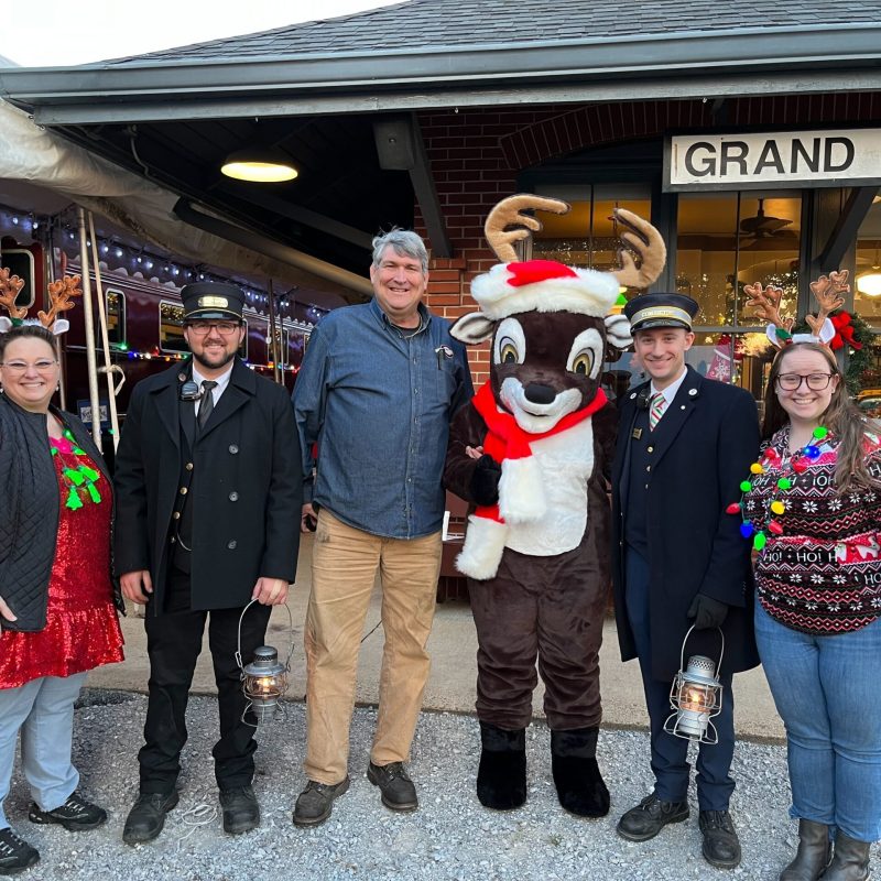 a group of people standing in front of a crowd posing for the camera