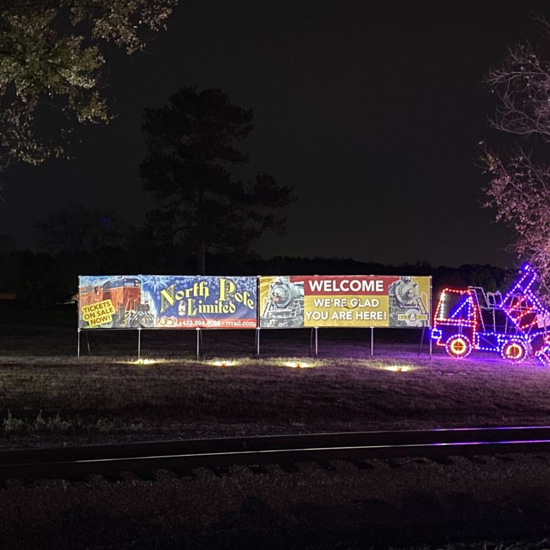 a sign lit up at night