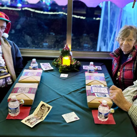 Guests enjoying holiday cocktails and treats aboard the Nightcap with St. Nick train at Tennessee Valley Railroad Museum.