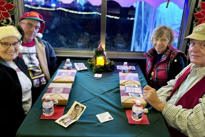 Guests enjoying holiday cocktails and treats aboard the Nightcap with St. Nick train at Tennessee Valley Railroad Museum.