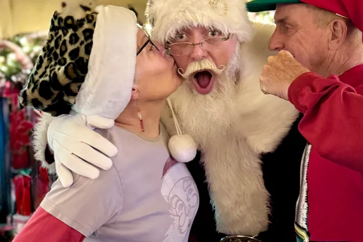 Guests share a fun, festive moment with Santa aboard the Nightcap with St. Nick holiday train ride.
