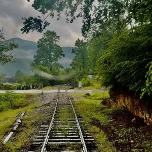 Vintage train traveling through the Hiwassee River Gorge near Delano, Tennessee – part of the Hiwassee Loop and Copperhill Special routes.