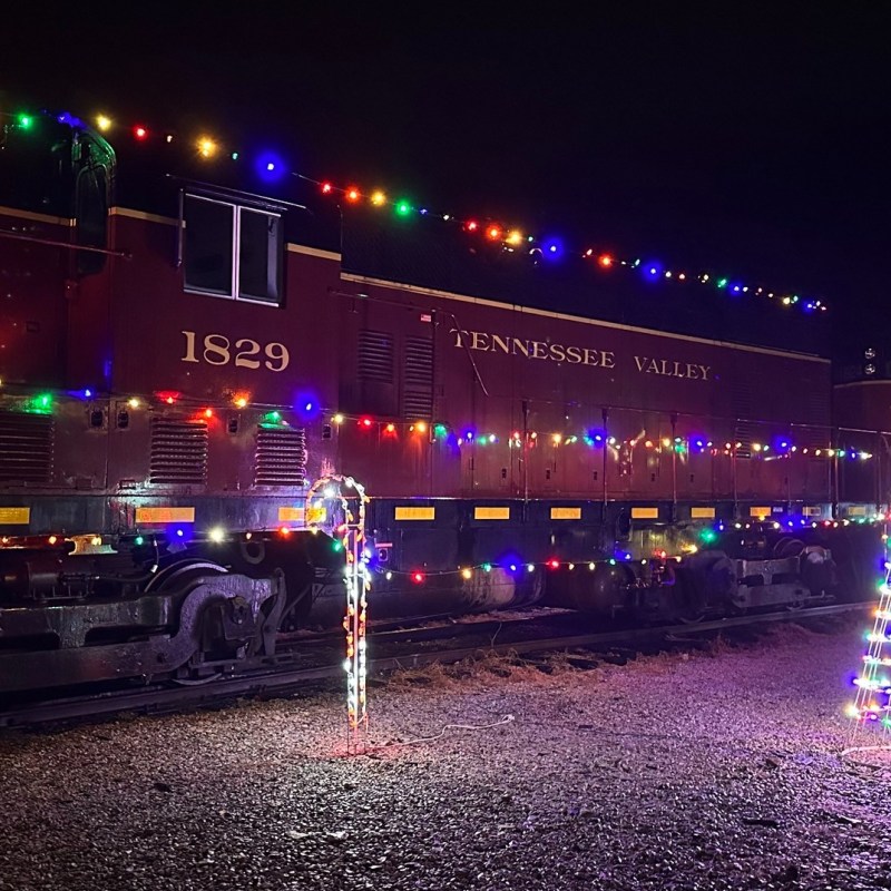 Tennessee Valley Railroad Engine 1829 decorated with holiday lights at night.