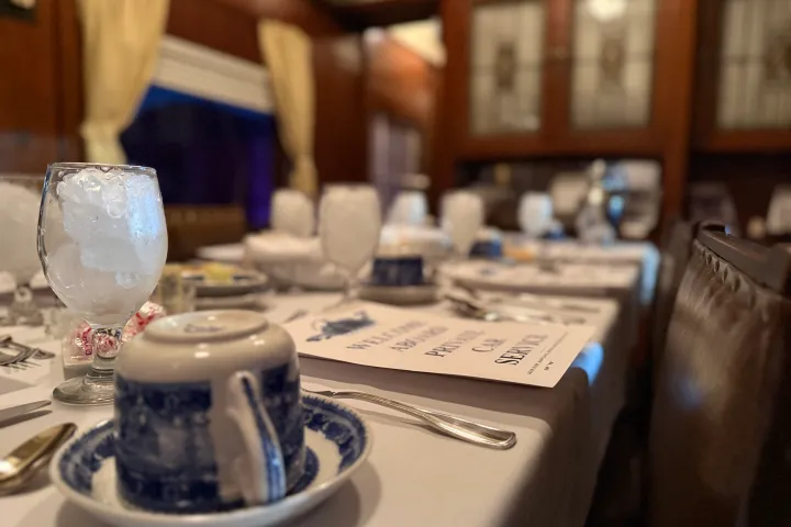 Elegant holiday table setting with china, glassware, and festive décor aboard the Tennessee Valley Railroad Christmas Lunch Train.