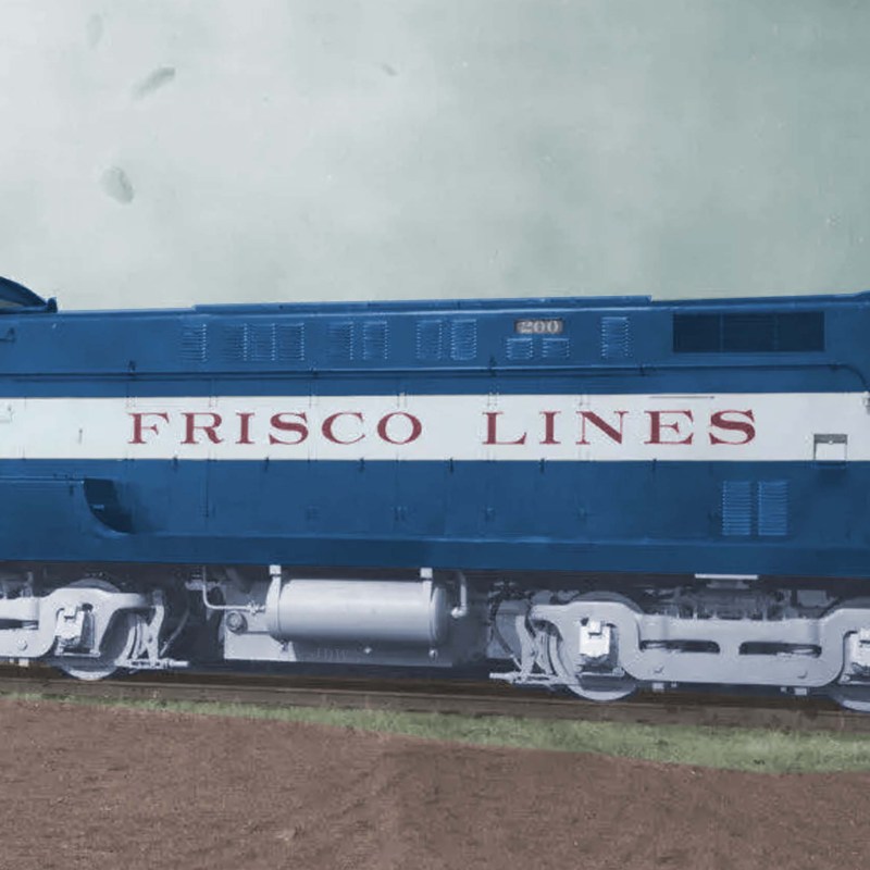 Vintage blue diesel locomotive with 'Frisco Lines' lettering on a track.